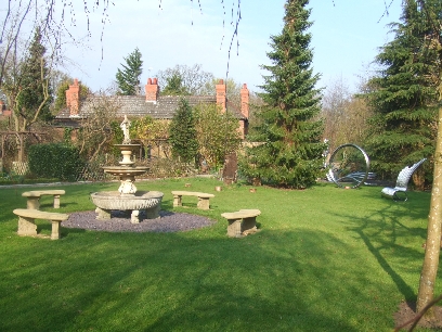 The Fountain Lawn with The Storytellers chair and 
Richard's and Dave's Garden Visible in the background